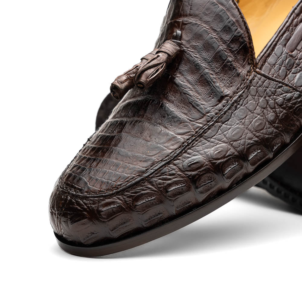 A pair of luxury men's Bianchi Brown tassel loafers by Marco Di Milano in genuine caiman crocodile—one upright, the other on its side to display the exquisite sole.