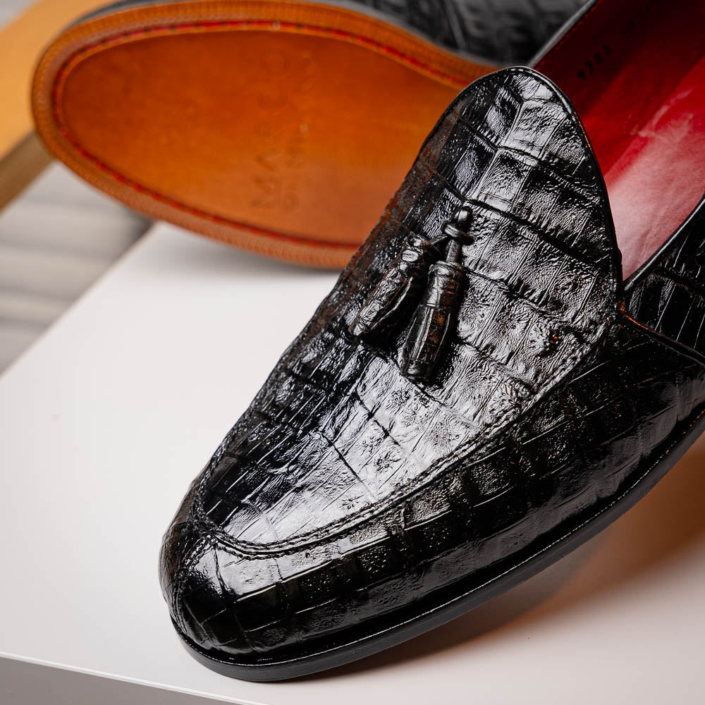 Experience luxury with the Marco Di Milano Bianchi Black—a pair of genuine caiman crocodile tassel loafers featuring black crocodile-patterned leather, red interior lining, and tan leather soles.