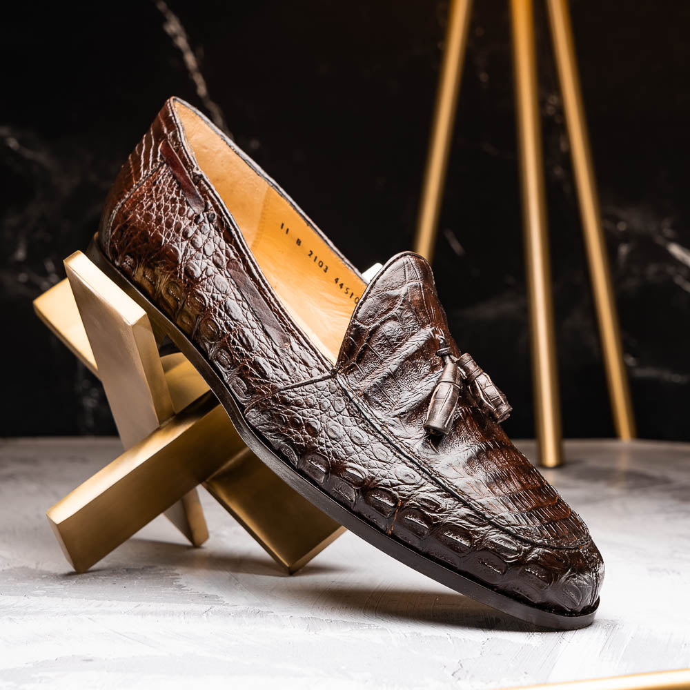A pair of luxury men's Bianchi Brown tassel loafers by Marco Di Milano in genuine caiman crocodile—one upright, the other on its side to display the exquisite sole.
