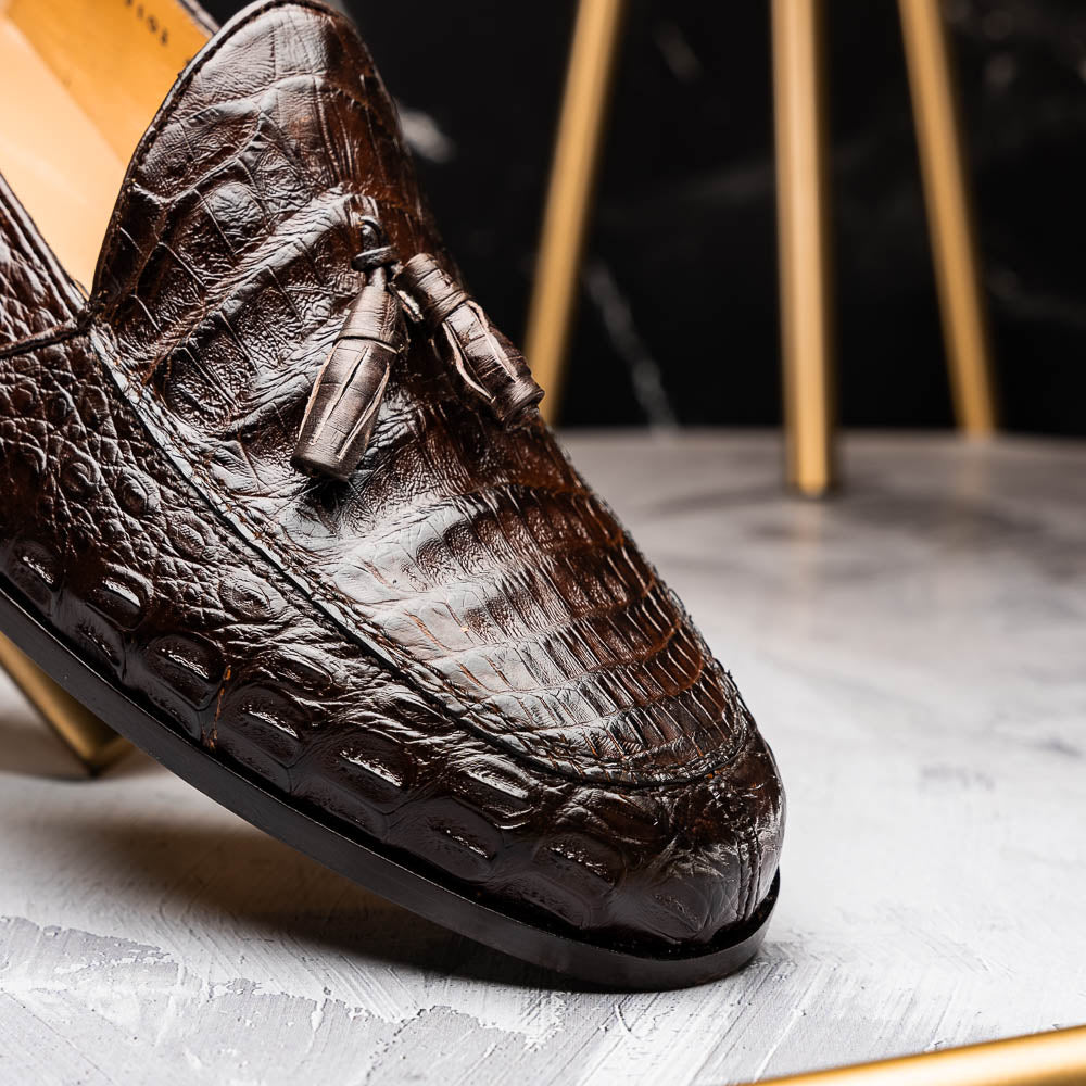 A pair of luxury men's Bianchi Brown tassel loafers by Marco Di Milano in genuine caiman crocodile—one upright, the other on its side to display the exquisite sole.