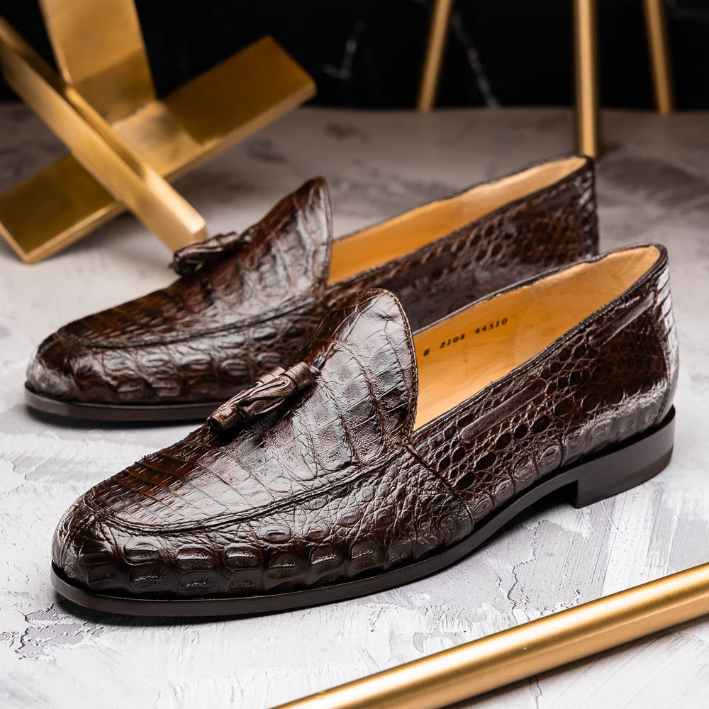 A pair of luxury men's Bianchi Brown tassel loafers by Marco Di Milano in genuine caiman crocodile—one upright, the other on its side to display the exquisite sole.