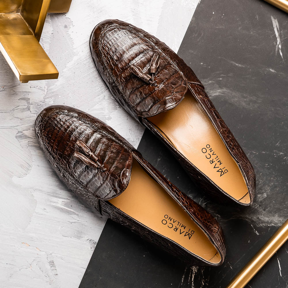 A pair of luxury men's Bianchi Brown tassel loafers by Marco Di Milano in genuine caiman crocodile—one upright, the other on its side to display the exquisite sole.