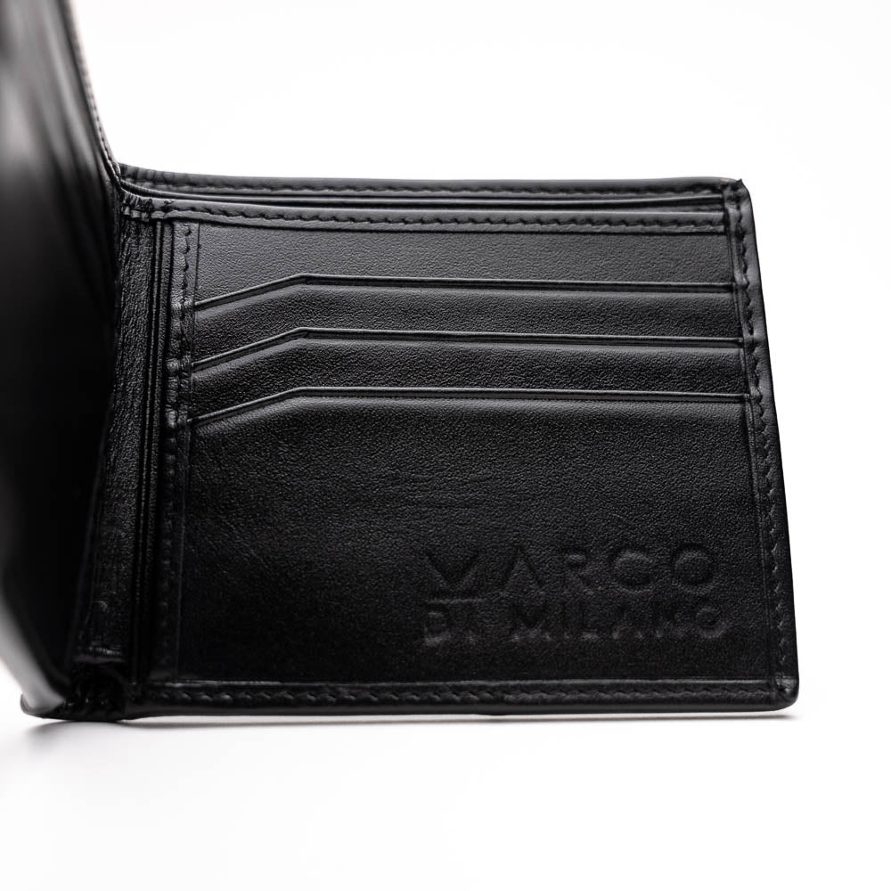 The Marco Di Milano Vallo Wallet Black is a textured luxury men's wallet with a central oval reflective accent, shown partially open on a white background.
