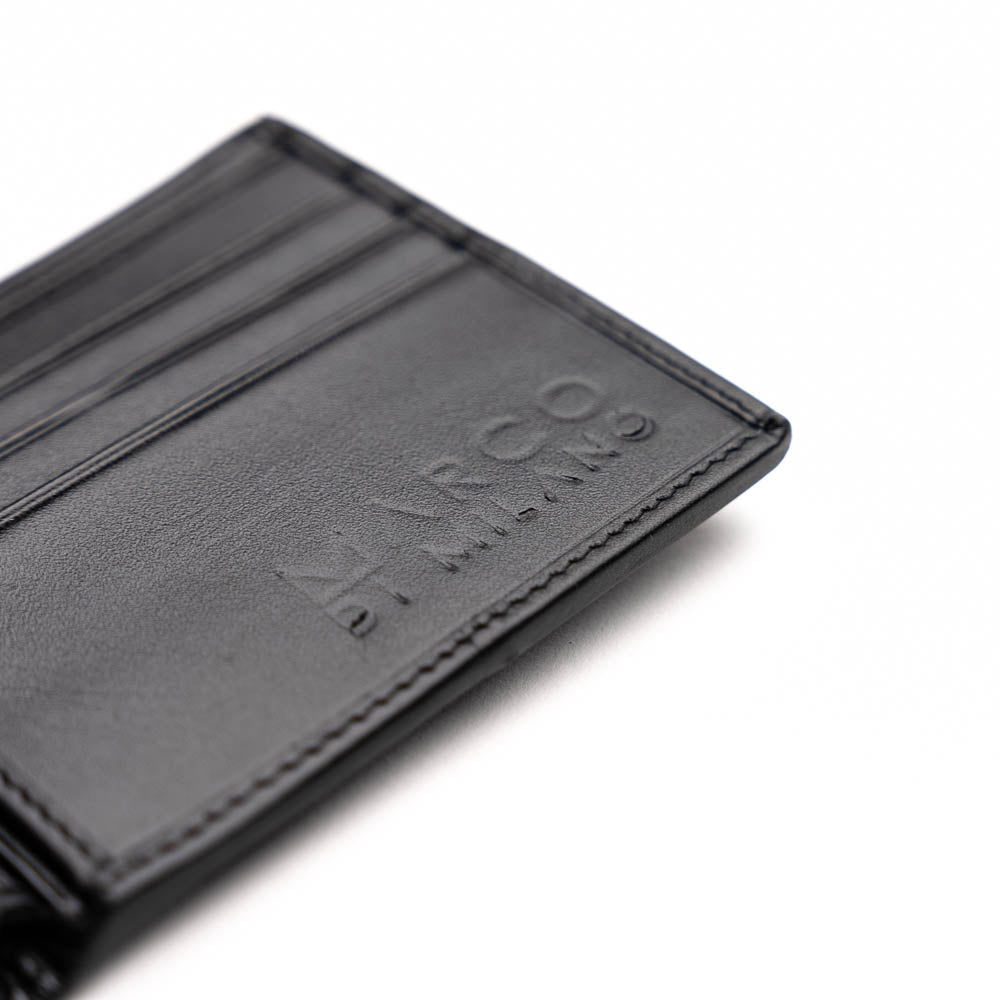 The Marco Di Milano Vallo Wallet Black is a textured luxury men's wallet with a central oval reflective accent, shown partially open on a white background.