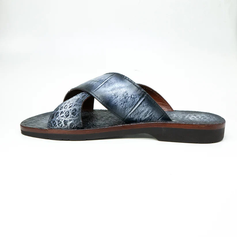 The Marco Di Milano Elios Newspaper is a single slip-on sandal featuring crossed grey textured leather straps and a flat sole, presented against a plain white background.