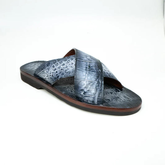 The Marco Di Milano Elios Newspaper is a single slip-on sandal featuring crossed grey textured leather straps and a flat sole, presented against a plain white background.