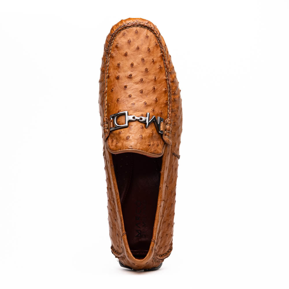 The Bolonia Brandy by Marco Di Milano—brown ostrich leather loafers with hand-painted finishes and metal buckles, one upright and one on its side revealing the sole—exude luxury, crafted from genuine exotic leather.