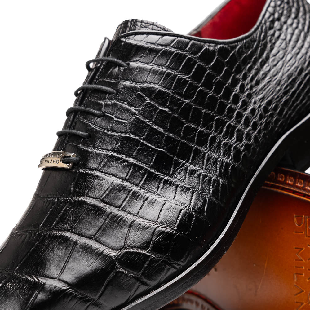 The Marco Di Milano Bono Black features a pair of luxury dress shoes in a crocodile pattern—one upright and one displaying a brown branded sole.