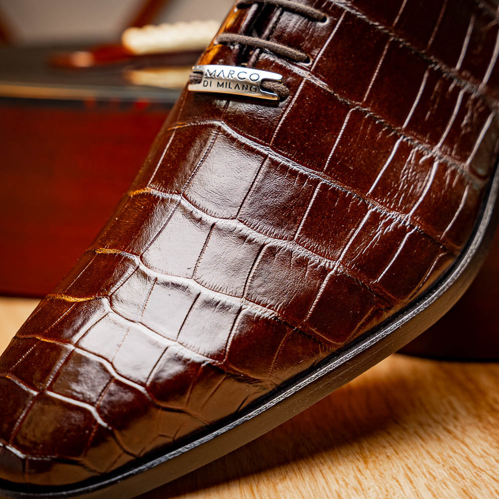 The Bono Brown by Marco Di Milano: genuine alligator Oxfords in brown—one upright displaying laces, the other showing the sole and stitching—a stunning example of luxury footwear.