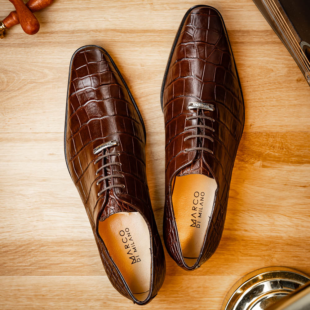 The Bono Brown by Marco Di Milano: genuine alligator Oxfords in brown—one upright displaying laces, the other showing the sole and stitching—a stunning example of luxury footwear.