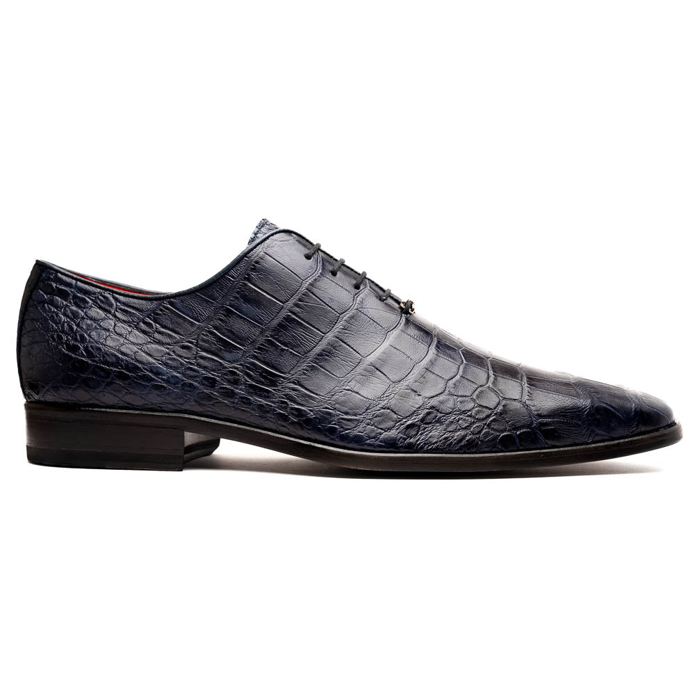 The Bono Navy by Marco Di Milano: luxury navy blue dress shoes with crocodile-patterned leather, black soles, and red inner lining. One shoe is positioned to showcase the sole.