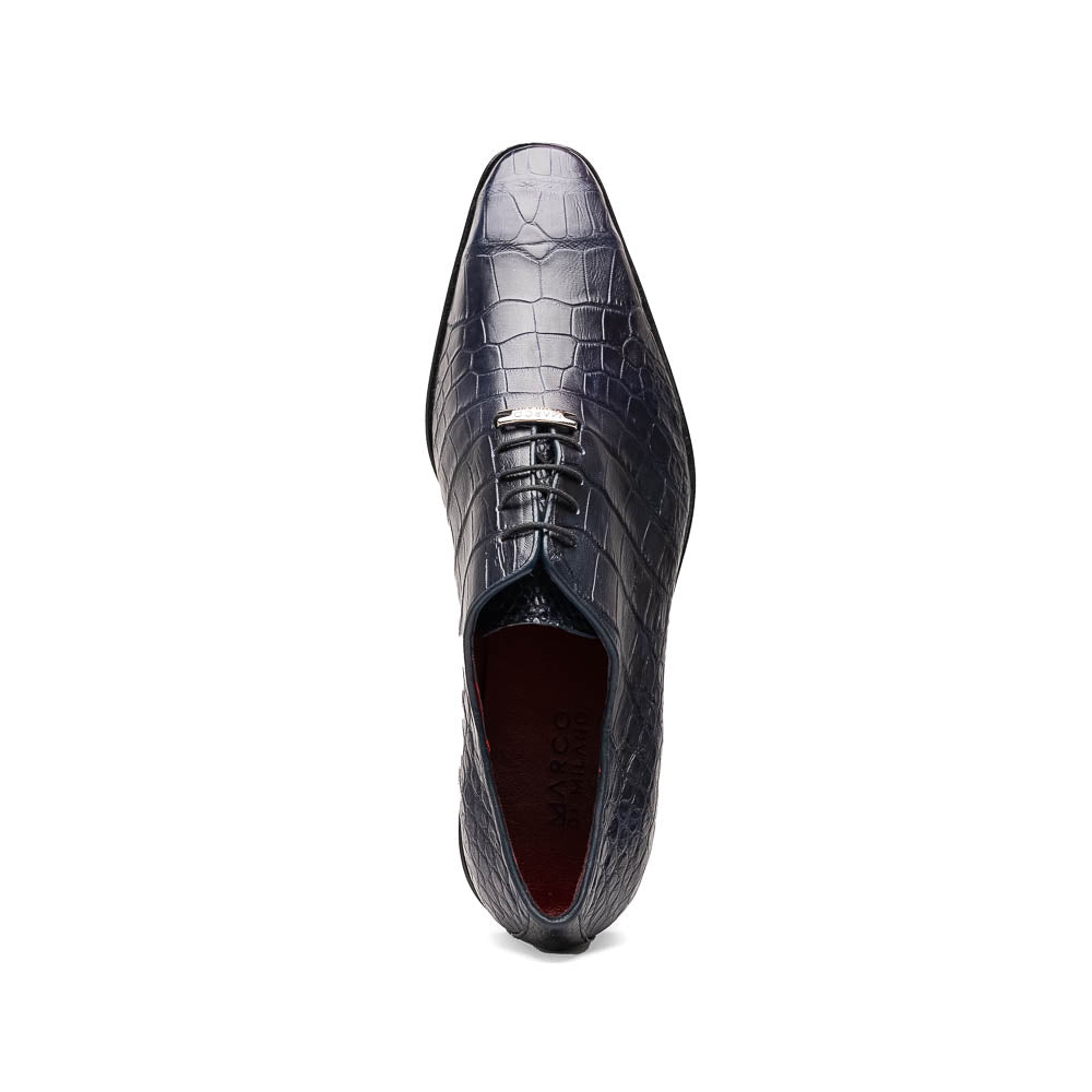 The Bono Navy by Marco Di Milano: luxury navy blue dress shoes with crocodile-patterned leather, black soles, and red inner lining. One shoe is positioned to showcase the sole.