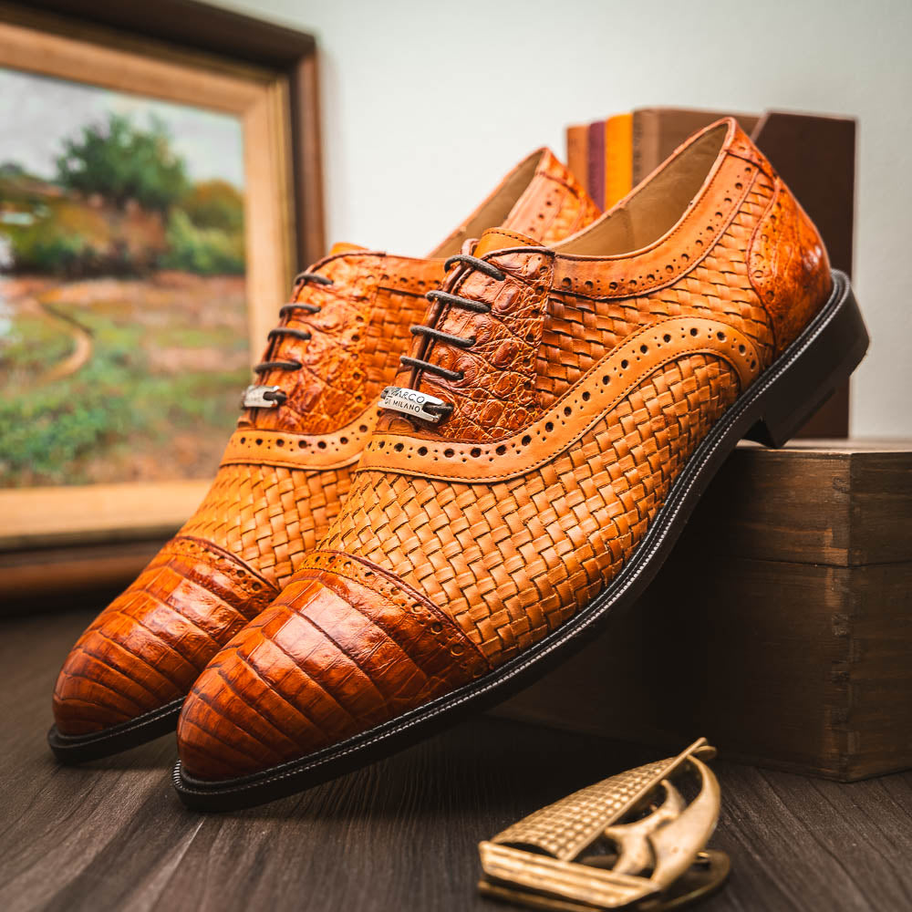 The John Brandy by Marco Di Milano is a pair of brown men’s oxford dress shoes with woven and textured leather, black laces, and stitched leather soles—ideal for those seeking luxury footwear.