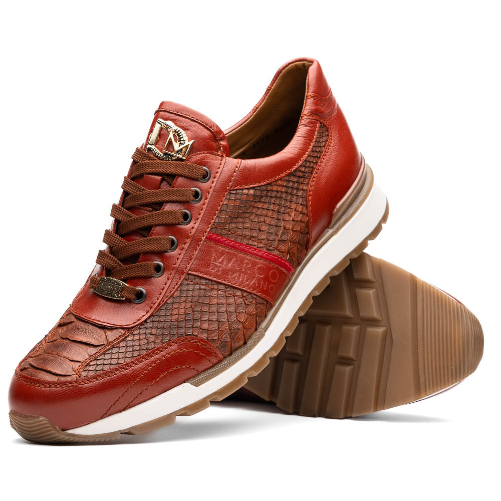The Marco Di Milano Brescia Antique Cognac sneakers feature brown textured leather, a patterned design, lace-up fronts, white midsoles, and tan rubber outsoles. One shoe is propped against the other.