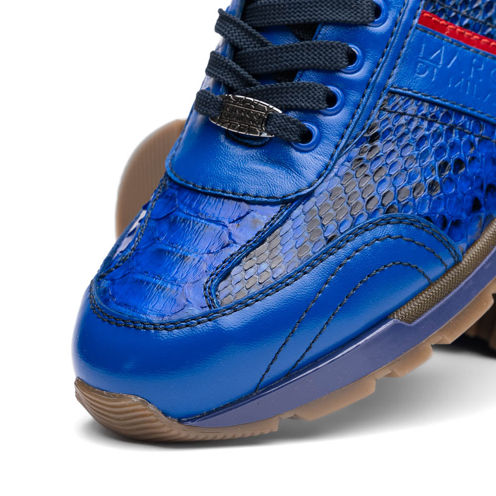 The Brescia Electric Blue sneakers by Marco Di Milano feature blue python leather, black laces, a red stripe, hand-painted side panels, and brown rubber soles—displayed with one shoe upright and the other on its side.