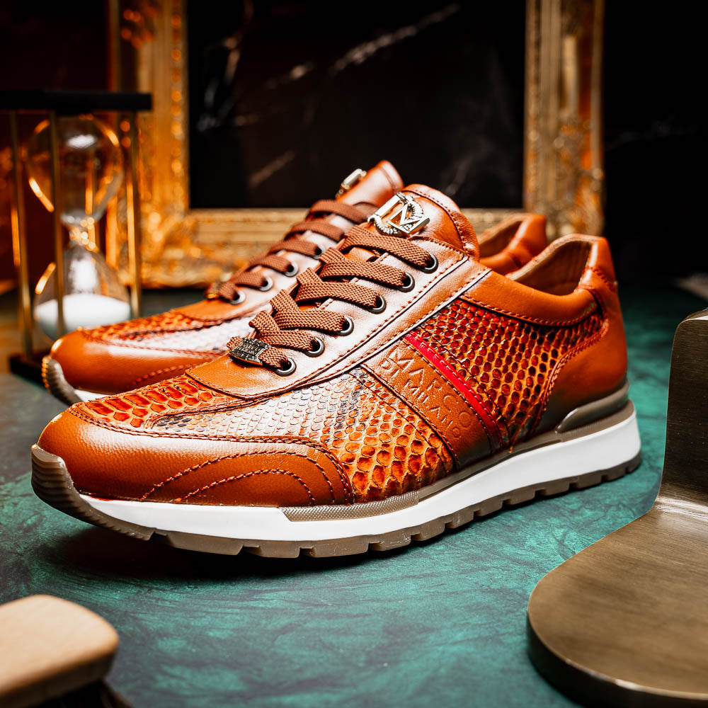 The Marco Di Milano Brescia Honey is a brown leather python fashion sneaker featuring a textured snakeskin pattern, red accent stripe, and thick rubber sole—luxury footwear redefined.