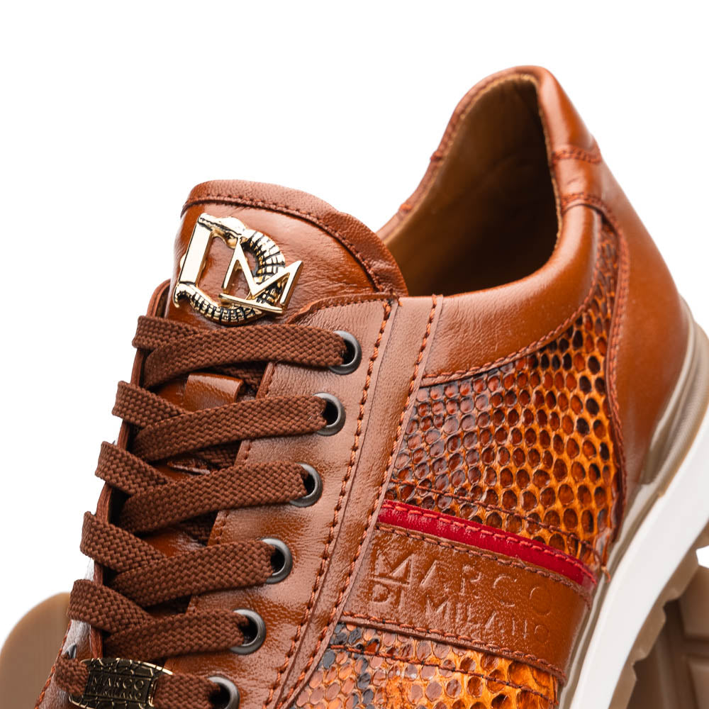 The Marco Di Milano Brescia Honey is a brown leather python fashion sneaker featuring a textured snakeskin pattern, red accent stripe, and thick rubber sole—luxury footwear redefined.