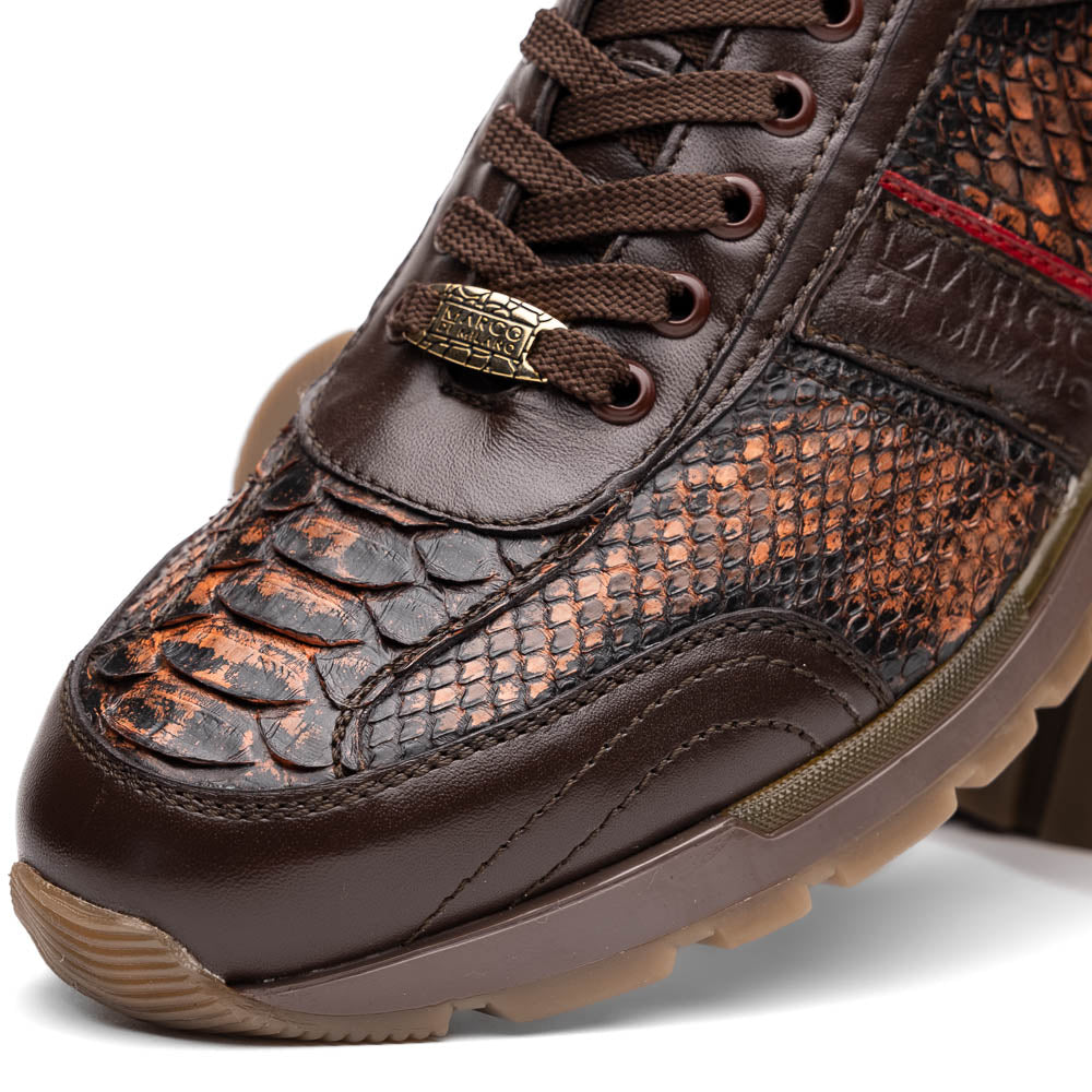 The Marco Di Milano Brescia Washed Cognac sneakers feature brown leather with a snakeskin pattern, gold accents, and rubber soles; one shoe is propped stylishly against the other, showcasing luxury footwear appeal.