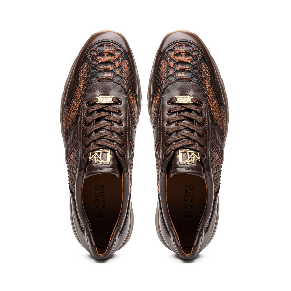 The Marco Di Milano Brescia Washed Cognac sneakers feature brown leather with a snakeskin pattern, gold accents, and rubber soles; one shoe is propped stylishly against the other, showcasing luxury footwear appeal.