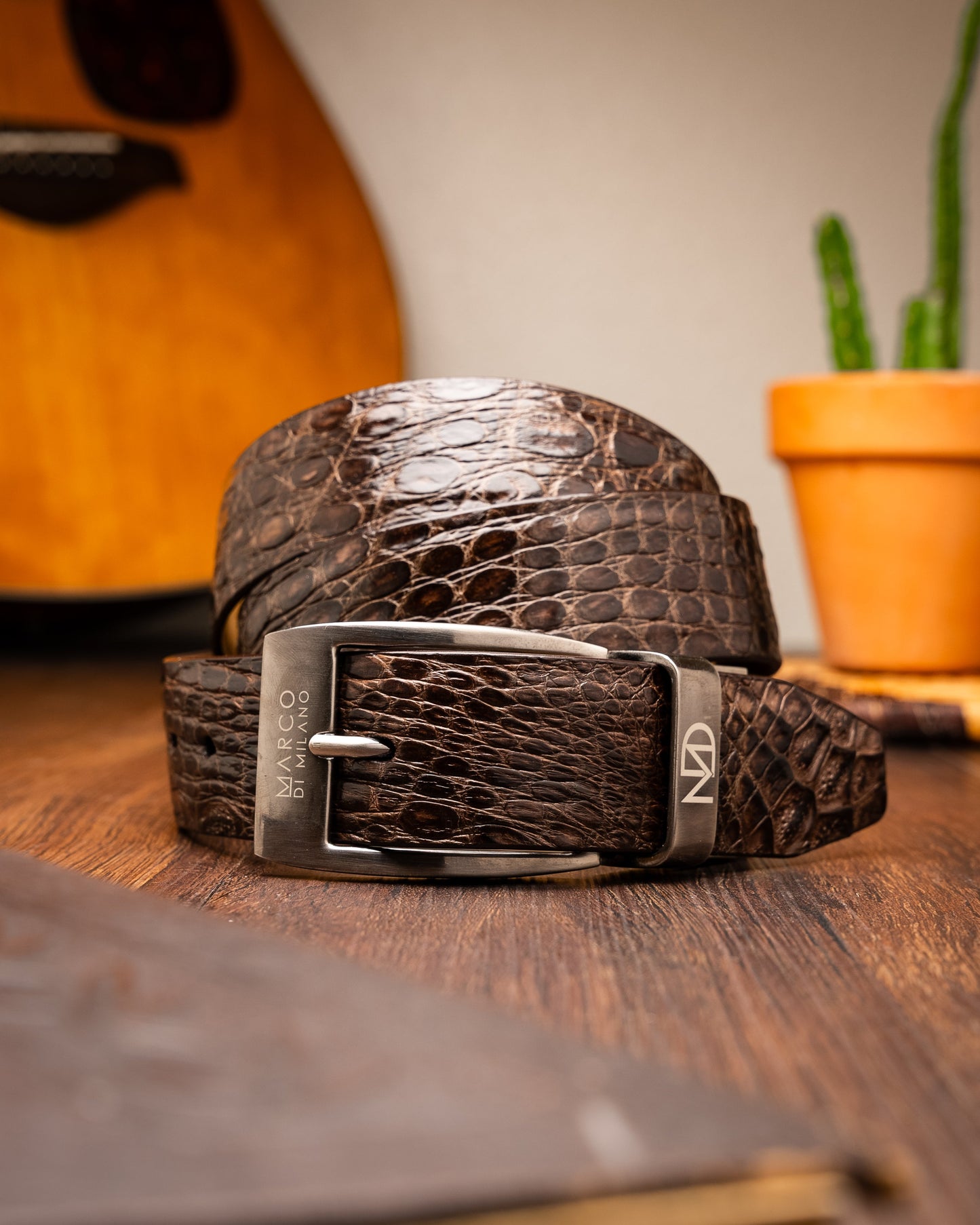 The Massimo Belt Brown by Marco Di Milano features an exotic caiman flank design and a silver engraved buckle—an elegant accessory to pair with your luxury footwear collection.