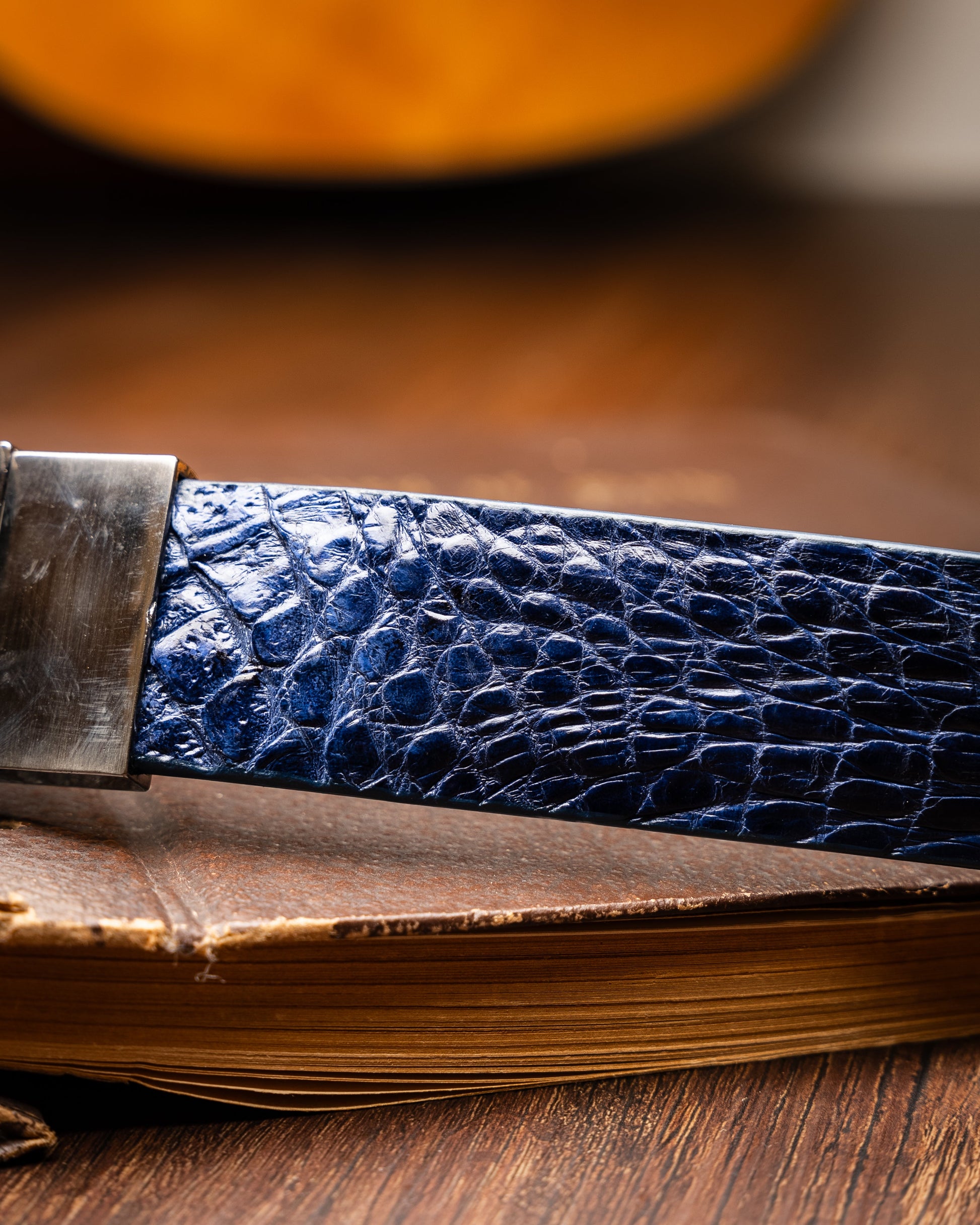The Massimo Belt Navy by Marco Di Milano features blue crocodile-embossed leather, a silver rectangular buckle engraved with "MD," inspired by genuine caiman flank belts, and finished with elegant hand-painted details.