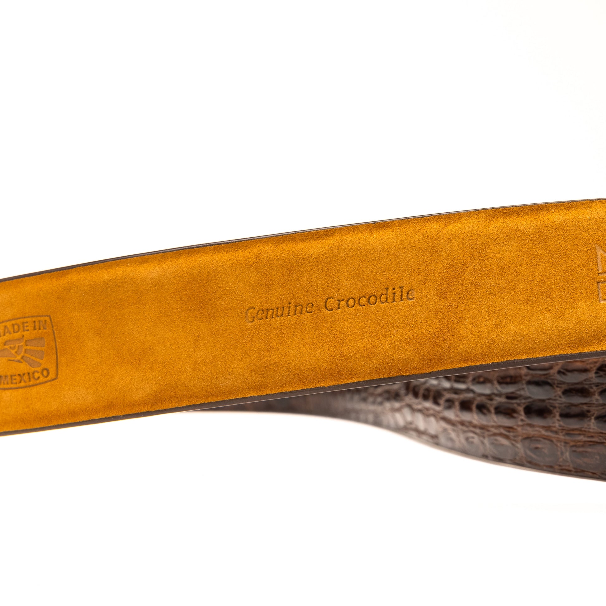 The Massimo Belt Brown by Marco Di Milano features an exotic caiman flank design and a silver engraved buckle—an elegant accessory to pair with your luxury footwear collection.