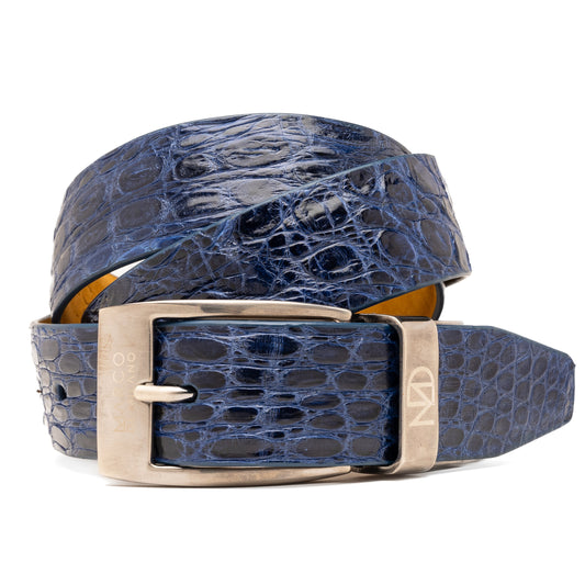The Massimo Belt Navy by Marco Di Milano features blue crocodile-embossed leather, a silver rectangular buckle engraved with "MD," inspired by genuine caiman flank belts, and finished with elegant hand-painted details.