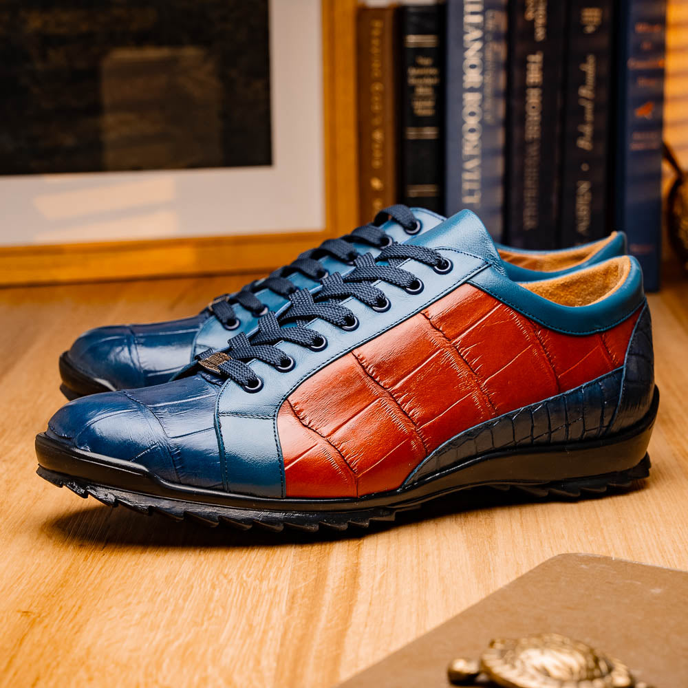 The Marco Di Milano Cairo Blue Jeans/Honey low-top sneakers showcase blue and orange genuine alligator leather with black laces and textured black rubber soles for a luxurious look.