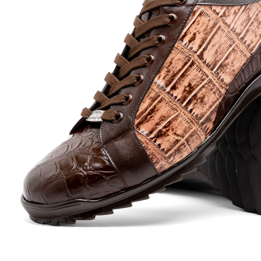 The Marco Di Milano Cairo Brown/Orix men's sneakers feature brown luxury footwear with textured panels and rubber soles, crafted to resemble genuine alligator. One shoe stands upright while the other lies on its side.