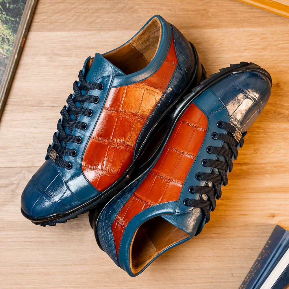 The Marco Di Milano Cairo Blue Jeans/Honey low-top sneakers showcase blue and orange genuine alligator leather with black laces and textured black rubber soles for a luxurious look.