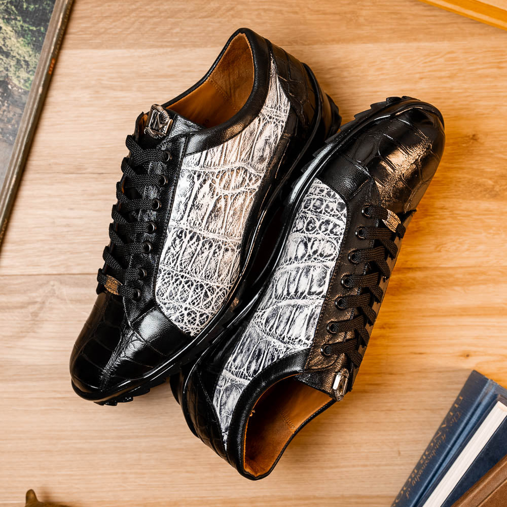 The Marco Di Milano Cairo Black/White sneakers feature a black and white low-top design, crocodile texture details, black laces, and thick black rubber soles—ideal for those seeking luxury footwear with a unique edge.