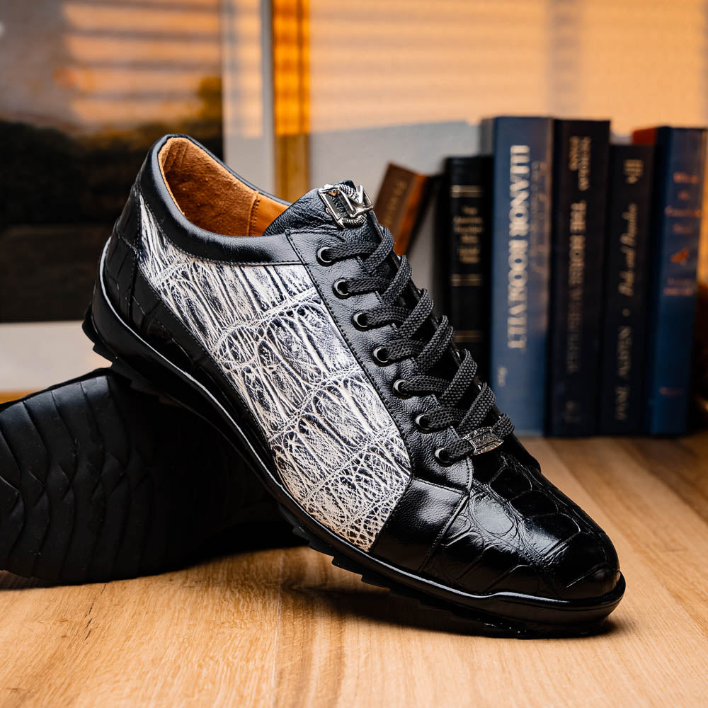 The Marco Di Milano Cairo Black/White sneakers feature a black and white low-top design, crocodile texture details, black laces, and thick black rubber soles—ideal for those seeking luxury footwear with a unique edge.