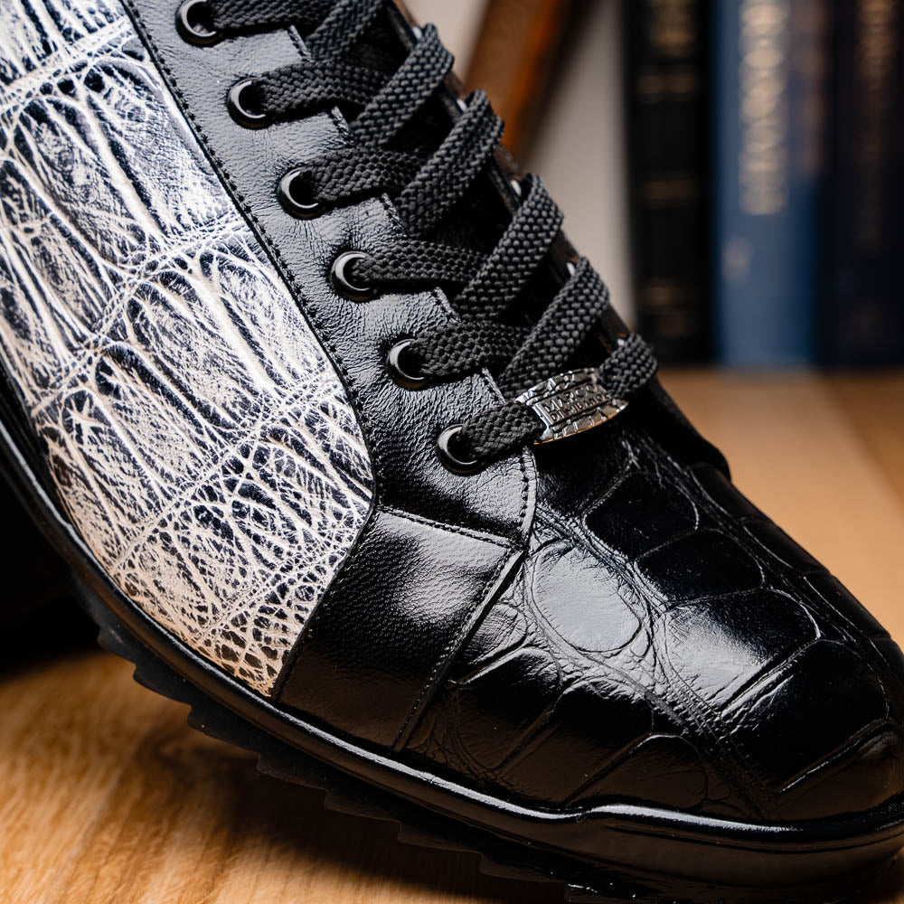 The Marco Di Milano Cairo Black/White sneakers feature a black and white low-top design, crocodile texture details, black laces, and thick black rubber soles—ideal for those seeking luxury footwear with a unique edge.