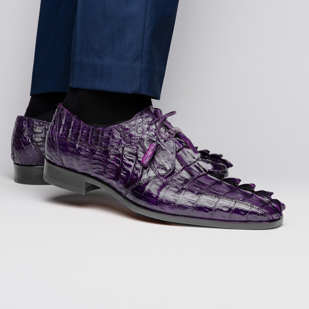 The Marco Di Milano Cancun Purple is a luxurious pair of derby shoes crafted from genuine hornback caiman crocodile leather, hand-painted in purple with black laces—one shown upright, the other displaying a tan branded sole.