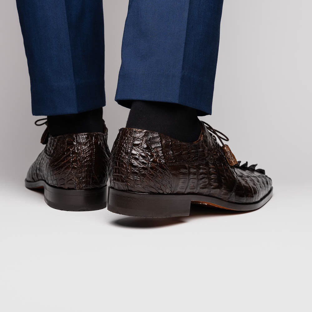 A pair of Marco Di Milano Cancun Brown derby shoes in dark brown hornback caiman crocodile leather—one displays the textured upper, while the other reveals the hand-painted exotic sole embossed with the brand.