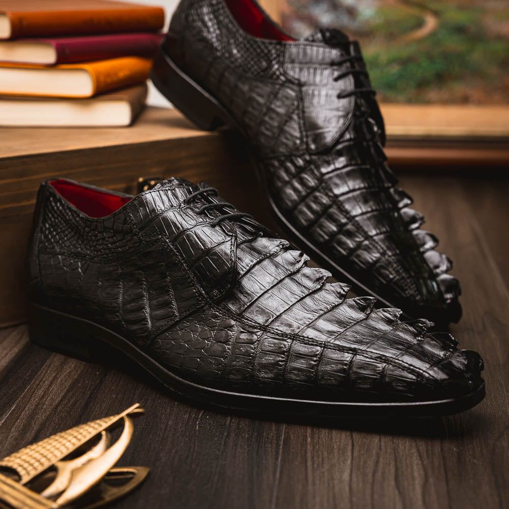The Marco Di Milano Cancun Black features genuine hornback caiman crocodile shoes with a pointed toe, one upright and the other showing the branded brown leather sole—a striking choice in men's exotic footwear.
