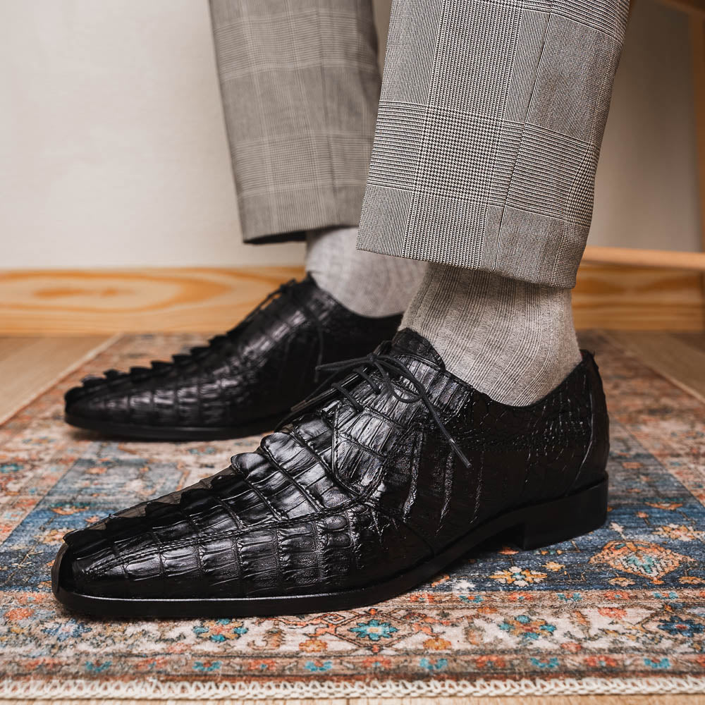 The Marco Di Milano Cancun Black features genuine hornback caiman crocodile shoes with a pointed toe, one upright and the other showing the branded brown leather sole—a striking choice in men's exotic footwear.