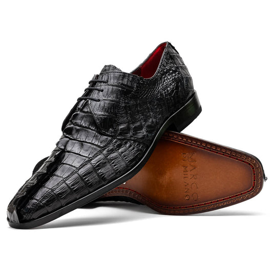 The Marco Di Milano Cancun Black features genuine hornback caiman crocodile shoes with a pointed toe, one upright and the other showing the branded brown leather sole—a striking choice in men's exotic footwear.