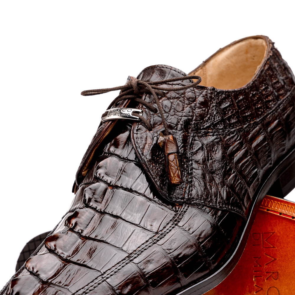 A pair of Marco Di Milano Cancun Brown derby shoes in dark brown hornback caiman crocodile leather—one displays the textured upper, while the other reveals the hand-painted exotic sole embossed with the brand.