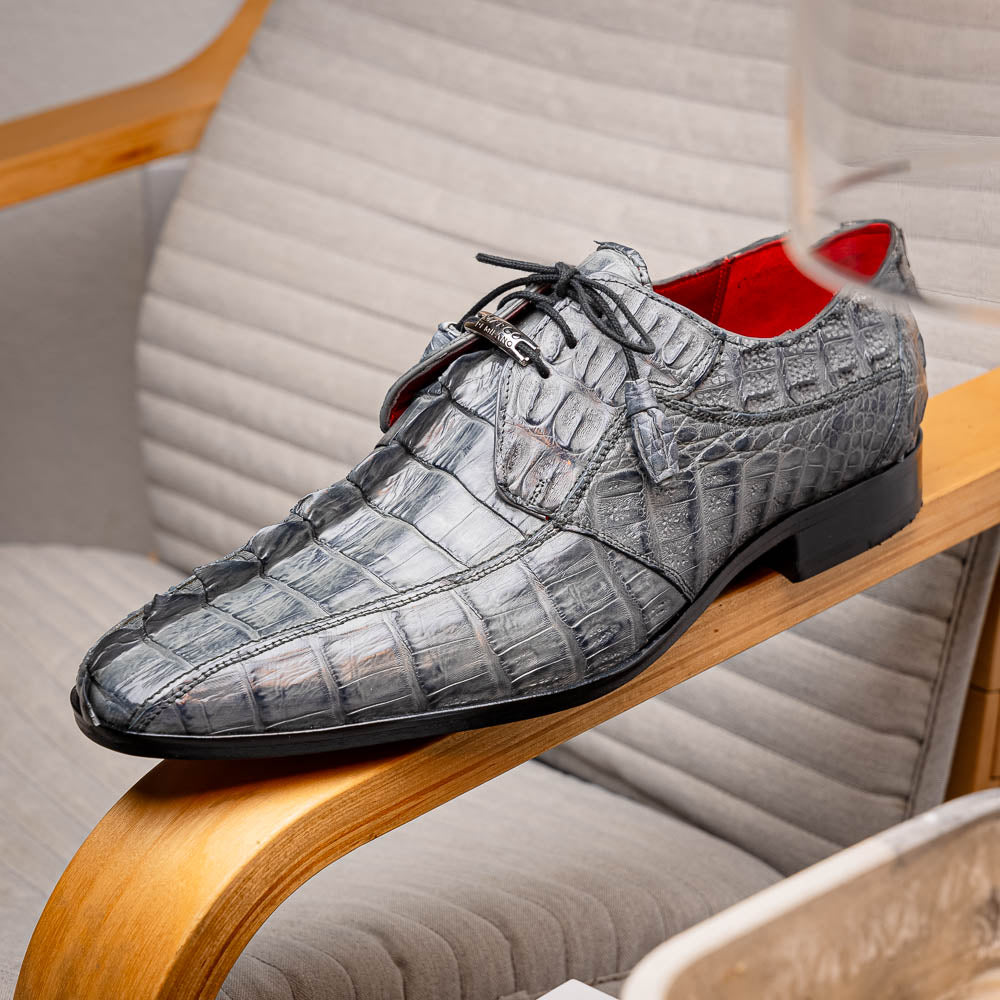 The Marco Di Milano Cancun Gray is a luxury men's derby shoe made from genuine hornback caiman crocodile leather in gray, with black laces, red lining, and brown leather soles—an exquisite choice in exotic footwear.