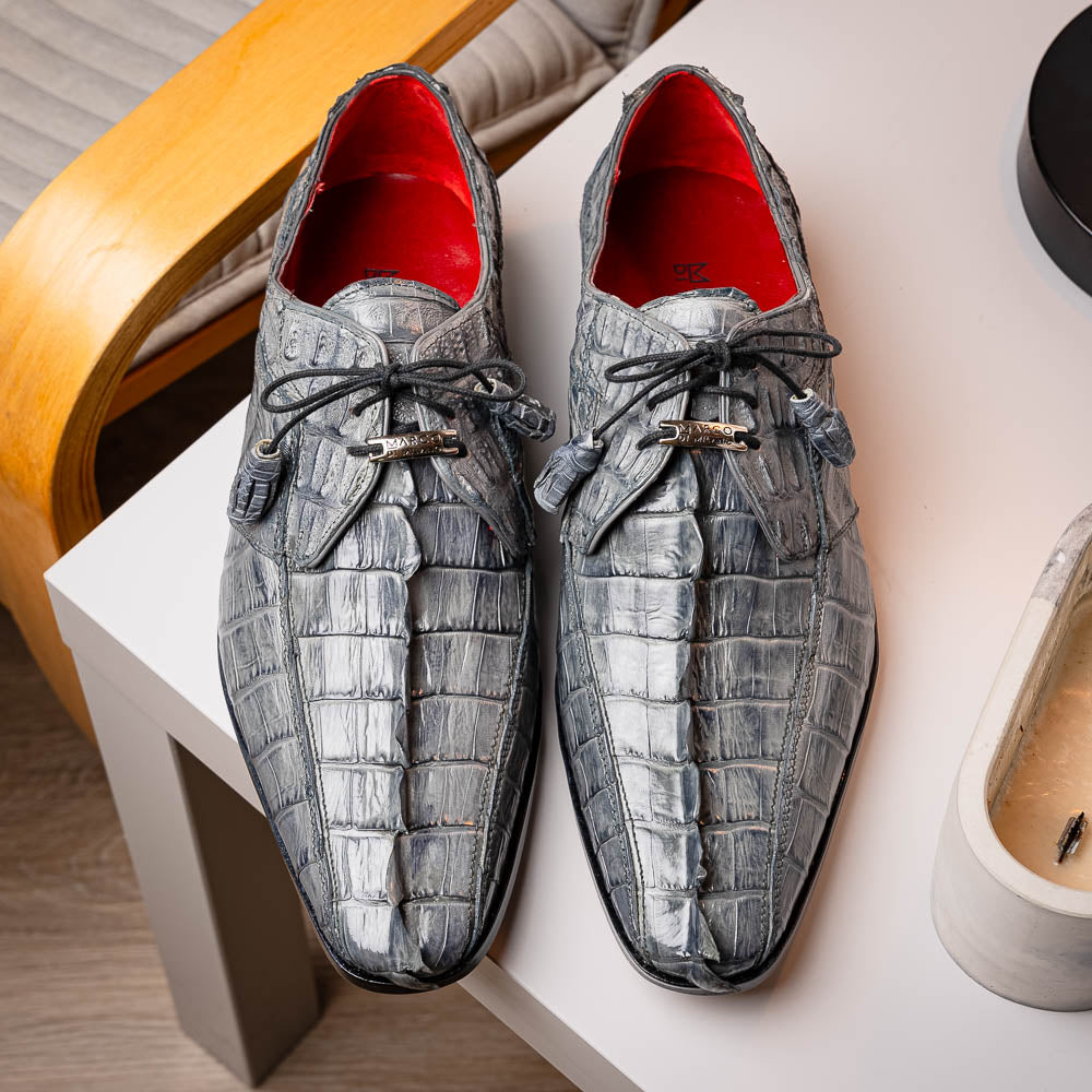 The Marco Di Milano Cancun Gray is a luxury men's derby shoe made from genuine hornback caiman crocodile leather in gray, with black laces, red lining, and brown leather soles—an exquisite choice in exotic footwear.