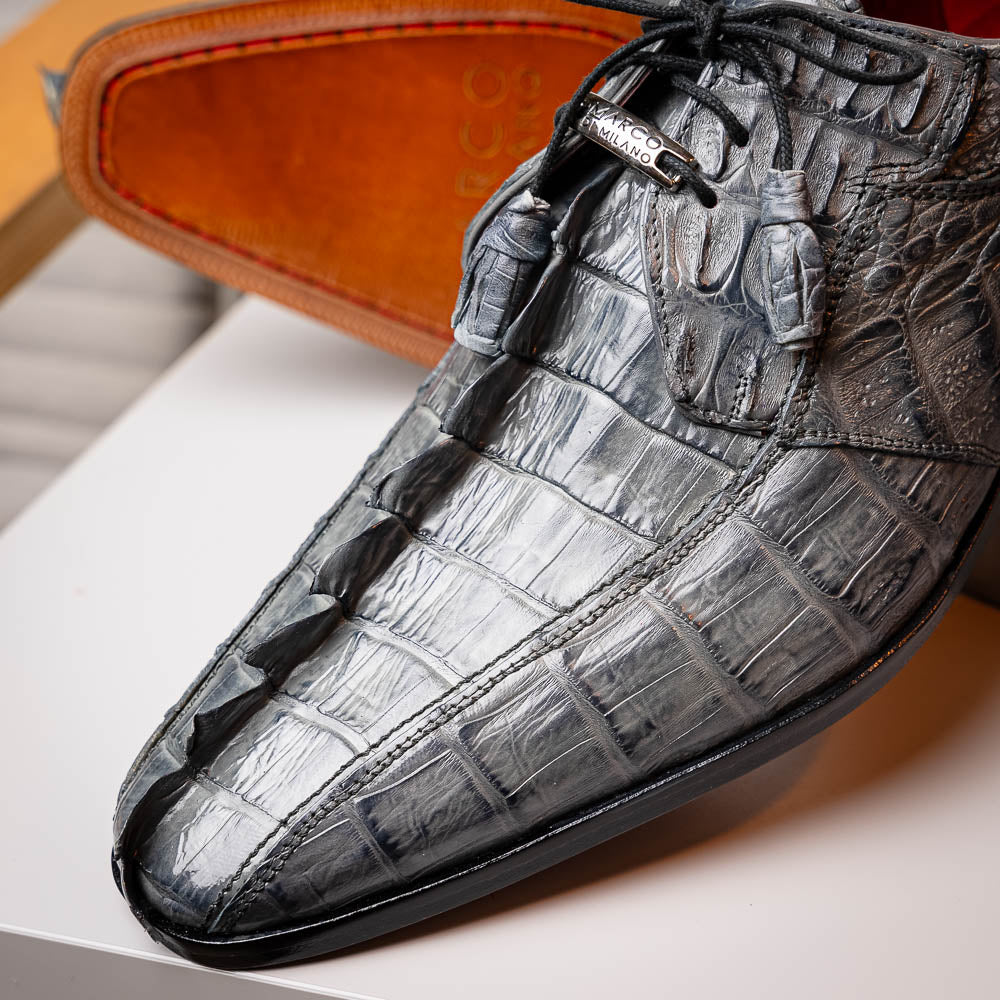 The Marco Di Milano Cancun Gray is a luxury men's derby shoe made from genuine hornback caiman crocodile leather in gray, with black laces, red lining, and brown leather soles—an exquisite choice in exotic footwear.