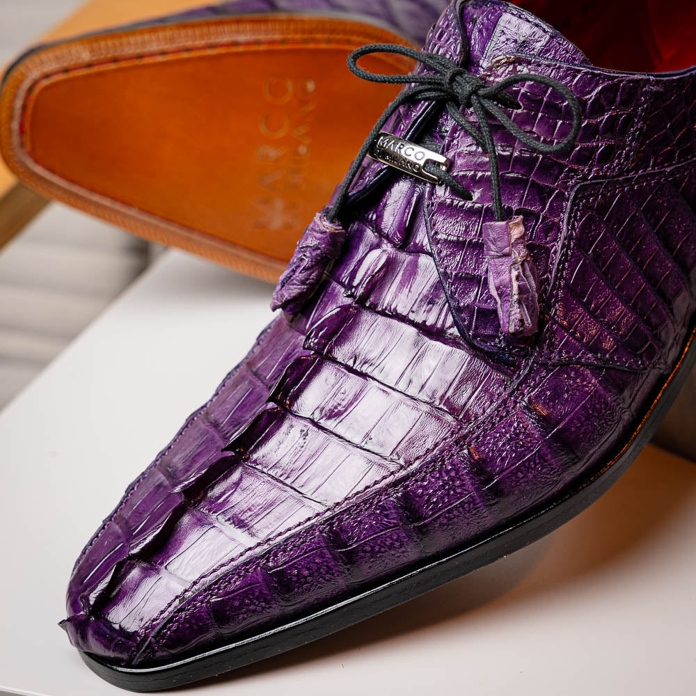 The Marco Di Milano Cancun Purple is a luxurious pair of derby shoes crafted from genuine hornback caiman crocodile leather, hand-painted in purple with black laces—one shown upright, the other displaying a tan branded sole.