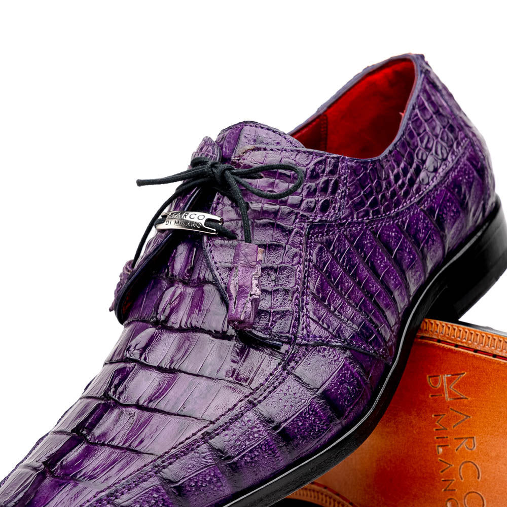 The Marco Di Milano Cancun Purple is a luxurious pair of derby shoes crafted from genuine hornback caiman crocodile leather, hand-painted in purple with black laces—one shown upright, the other displaying a tan branded sole.