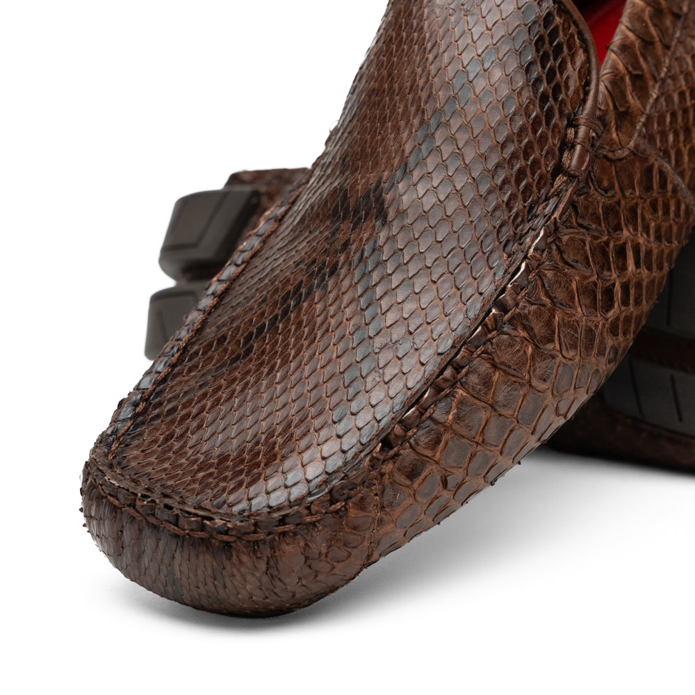 A pair of Capri Brown luxury exotic shoes by Marco Di Milano, crafted from genuine python leather, with one handcrafted men’s loafer standing upright and the other displayed on its side to highlight the intricately textured sole.