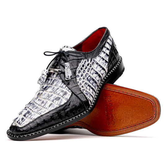 A pair of Marco Di Milano Caribe Newspaper / Black luxury dress shoes crafted from genuine hornback caiman crocodile leather, with one upright and the other on its side showing the brown sole and exquisite hand-painted details.