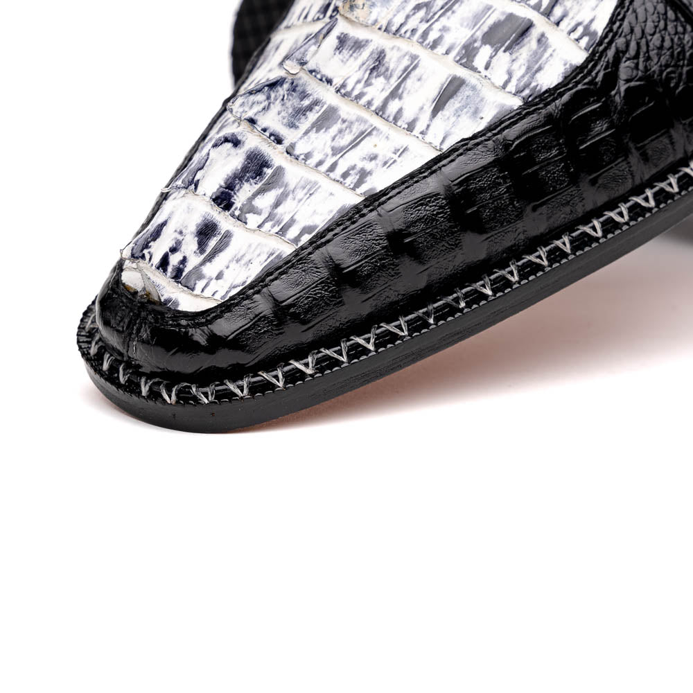 A pair of Marco Di Milano Caribe Newspaper / Black luxury dress shoes crafted from genuine hornback caiman crocodile leather, with one upright and the other on its side showing the brown sole and exquisite hand-painted details.