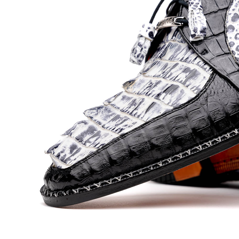 A pair of Marco Di Milano Caribe Newspaper / Black luxury dress shoes crafted from genuine hornback caiman crocodile leather, with one upright and the other on its side showing the brown sole and exquisite hand-painted details.