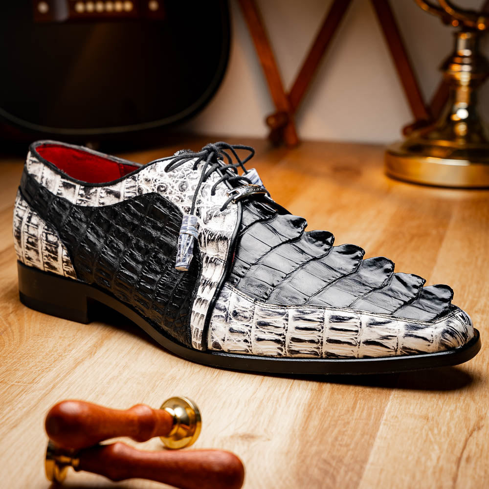 The Marco Di Milano Caribe Black / Newspaper are luxury men's derby shoes crafted from genuine hornback caiman crocodile leather in black and white, featuring red lining, leather soles, lace-up closures, and decorative tassels.