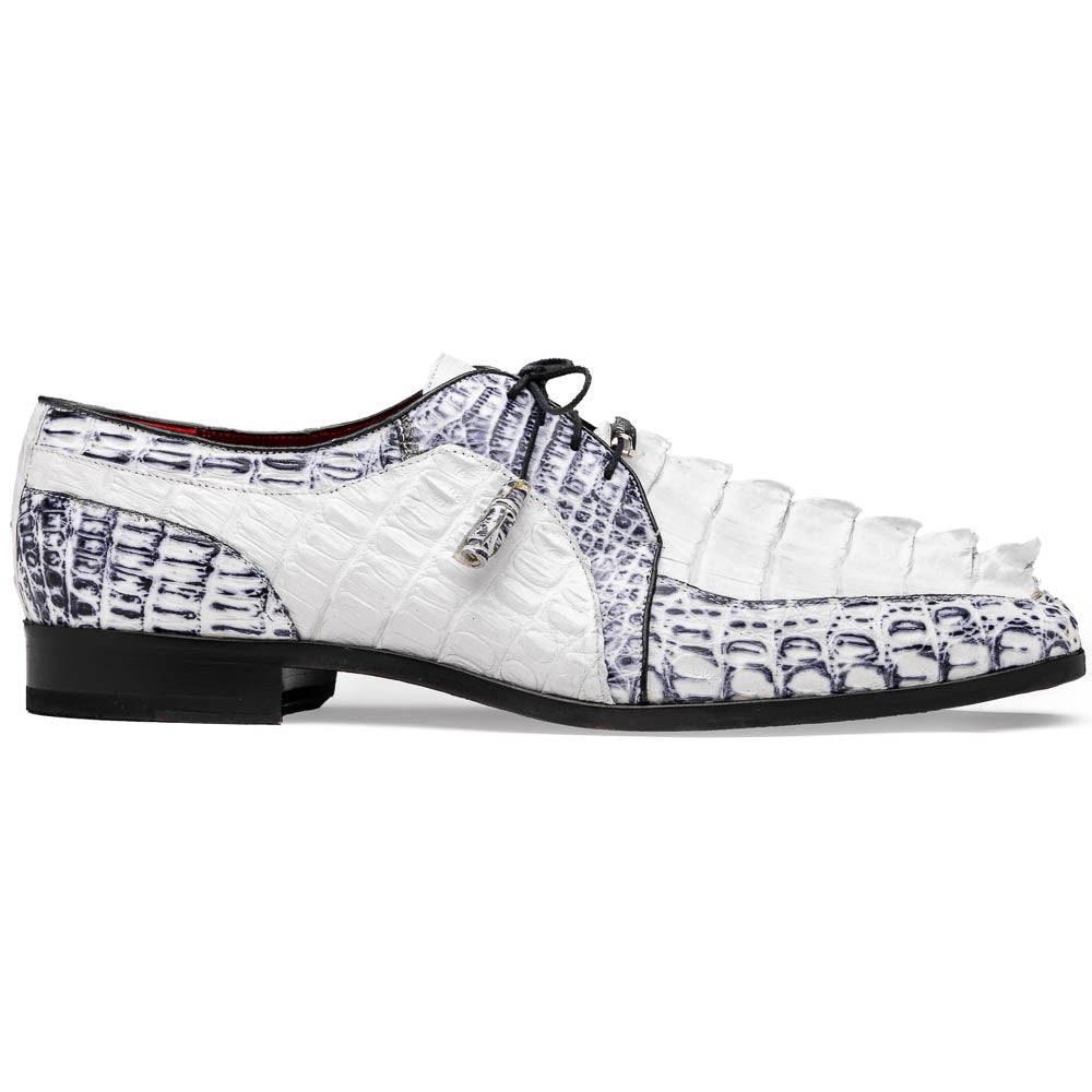 The Marco Di Milano Caribe White / Newspaper Derby shoes feature white and black crocodile-patterned leather, one upright and one on its side to showcase a brown leather sole with red stitching—distinctive, exotic hand-painted footwear.